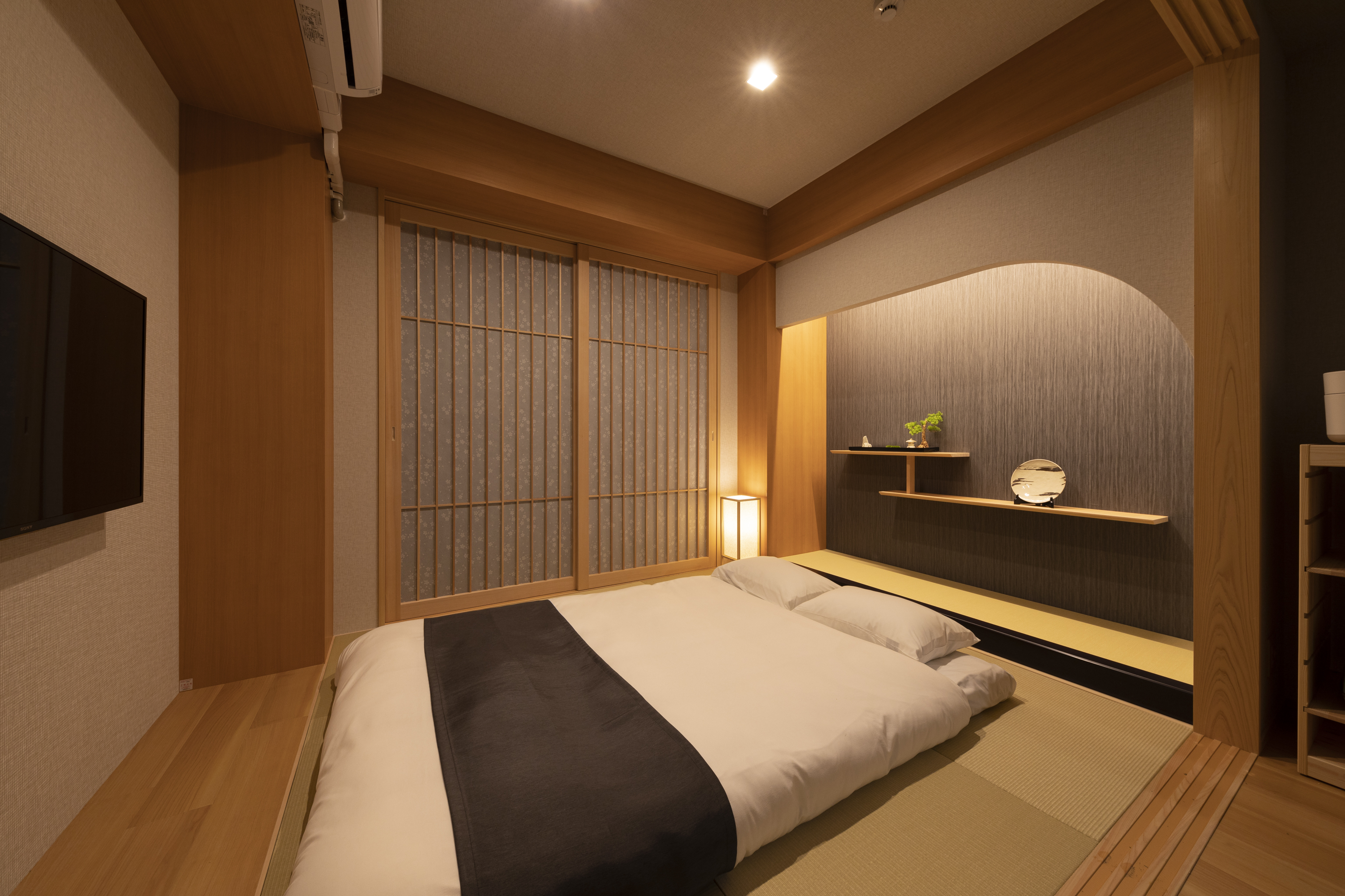 A dimly lit wood paneled bedroom