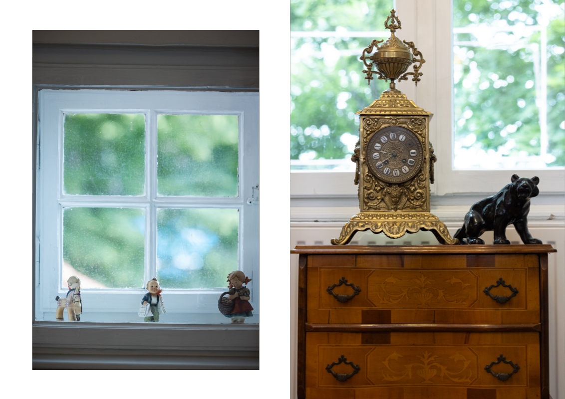 Three small statues and an ancient standing clock as decoration. 