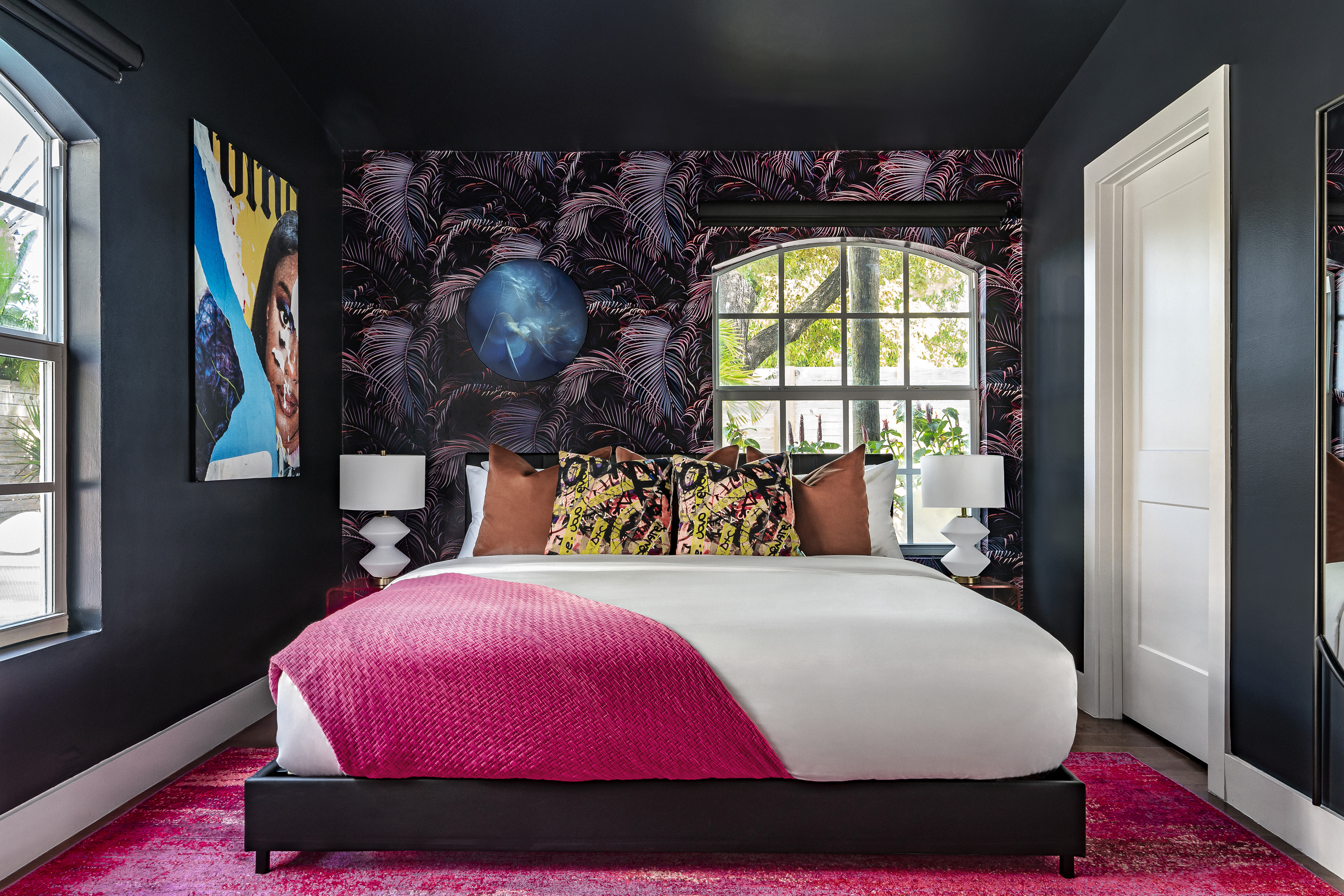 La La Land bedroom with pink rug and dark accent walls