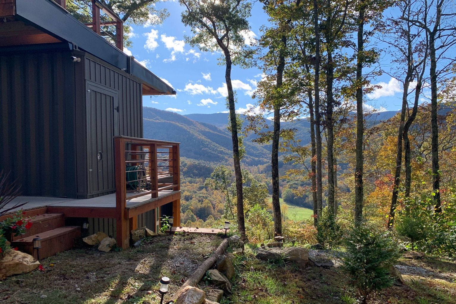 Exterior shot of a converted container cabin with views of the Appalachian hills.