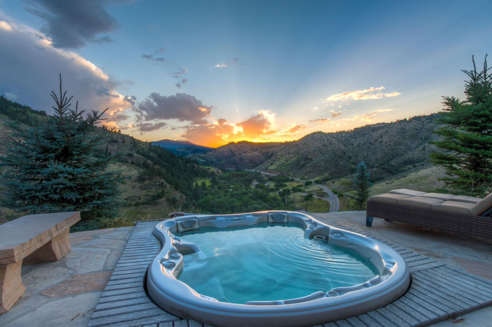 Hot tub with panoramic views of Colorado hills by sunset.