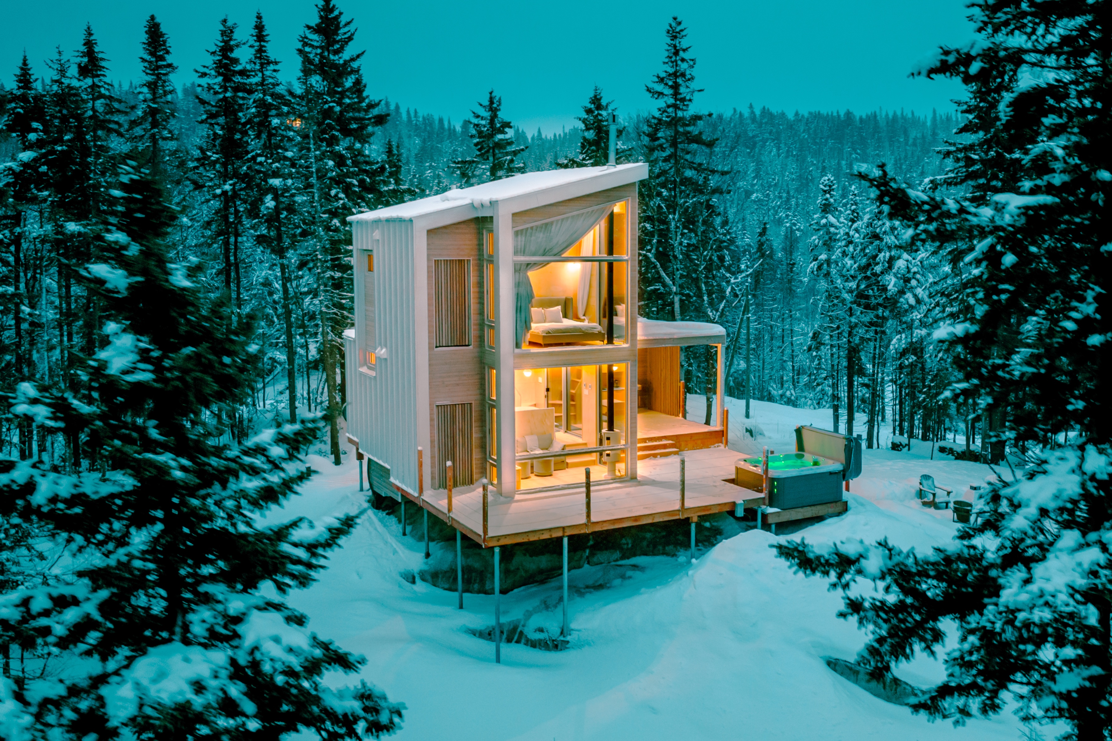 An open-concept home at twilight during winter.