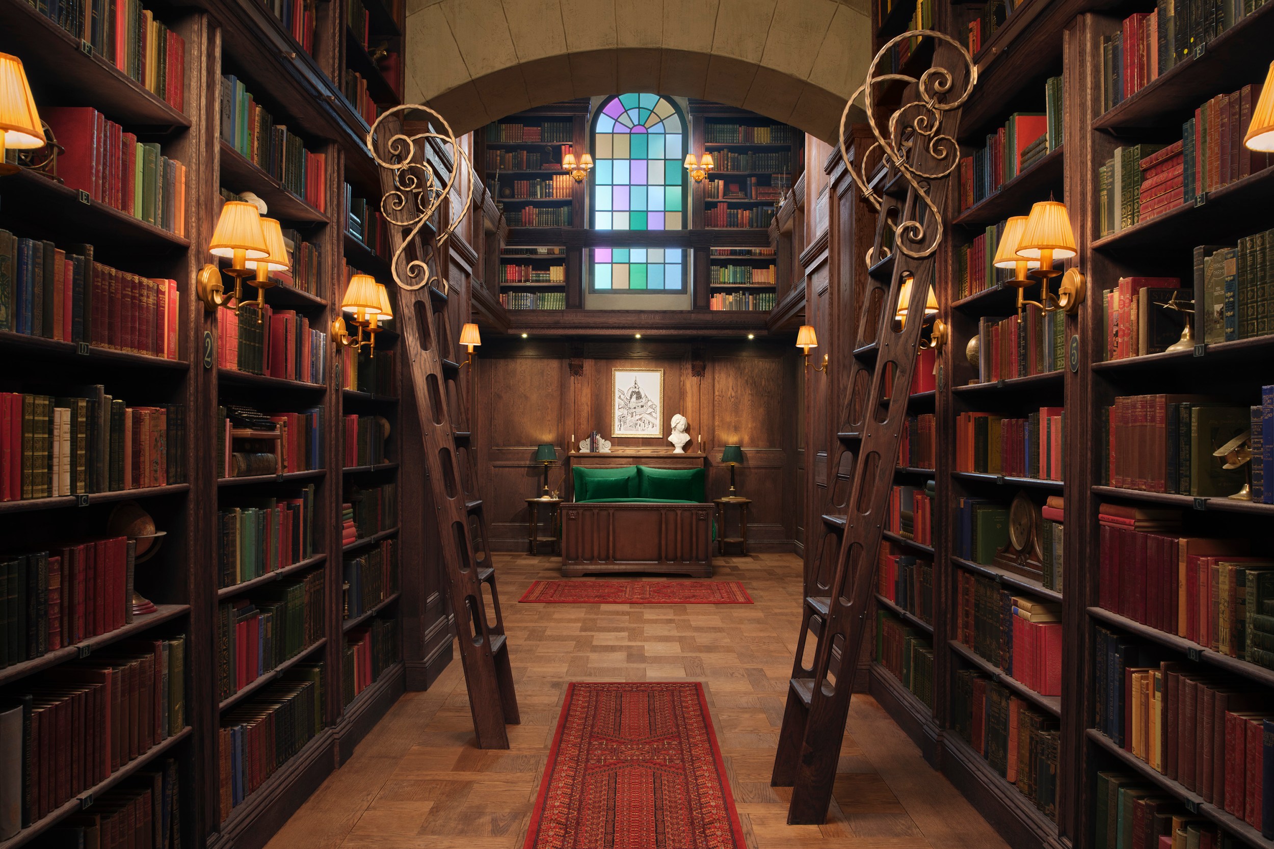 The bedroom section of the Hidden Library, a book lined and wood panelled room.