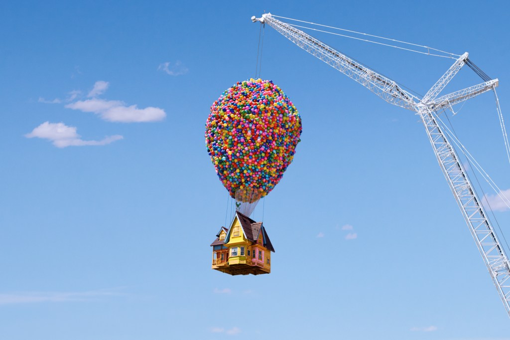 Home from the movie Up! lifted by a crane in the sky with thousands of balloons attached to the roof
