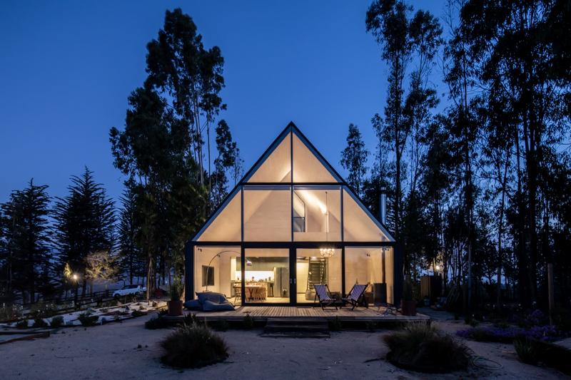 House of glass with white interiors and lights on