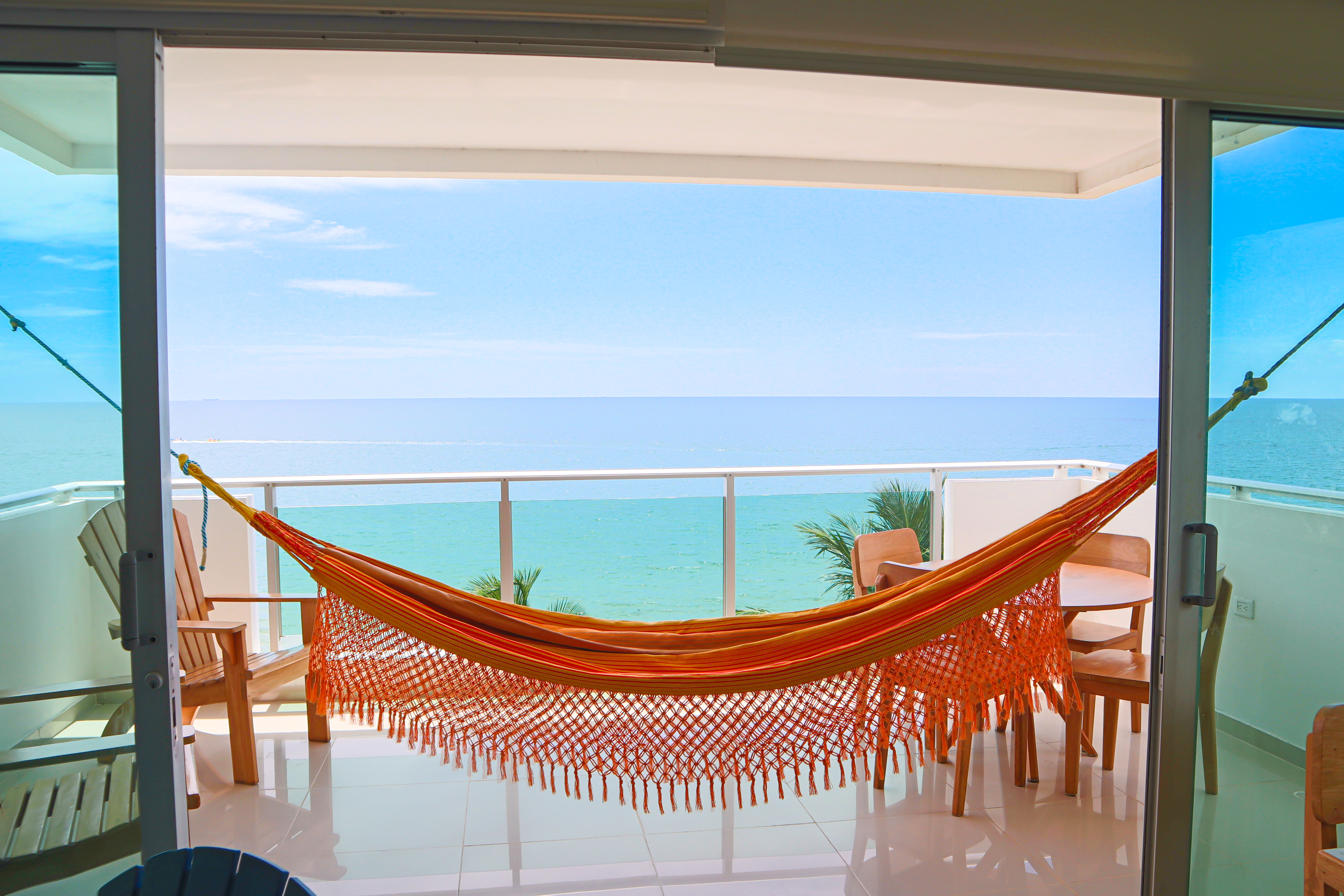 View of a hammock in a balcony of an apartment in Coveñas, Colombia, with a view of the Caribbean sea in the back