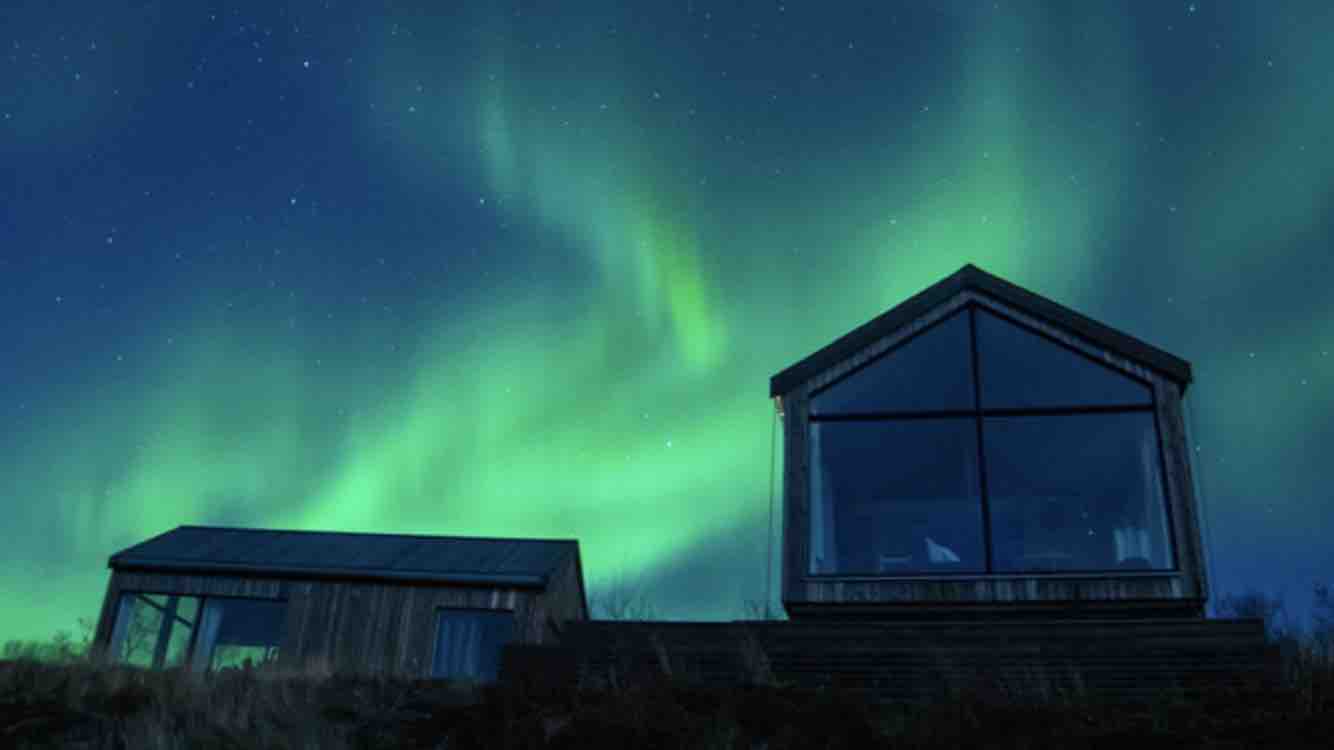 Lodge with window with Northern Lights view