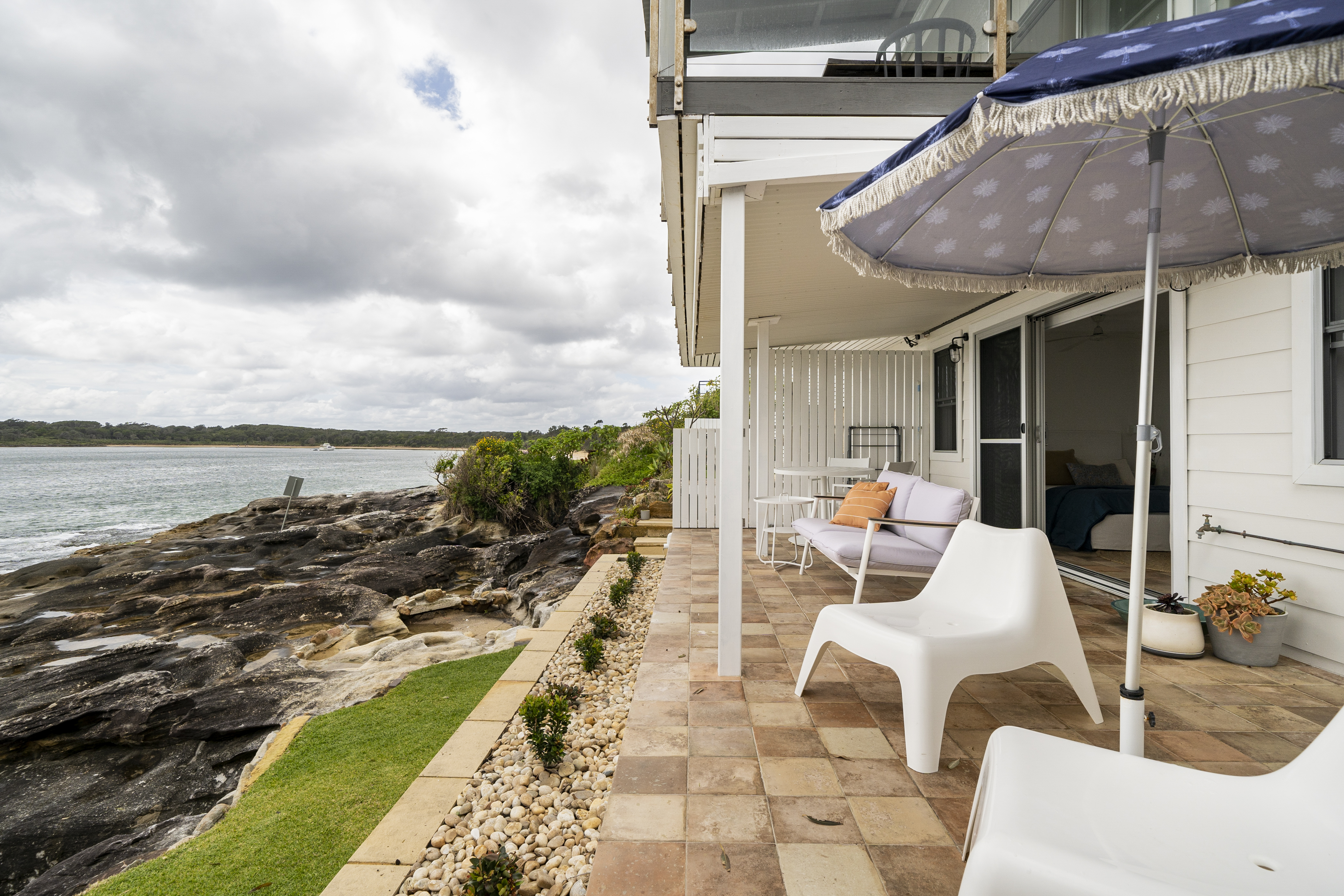 Outdoor patio that is right by the water