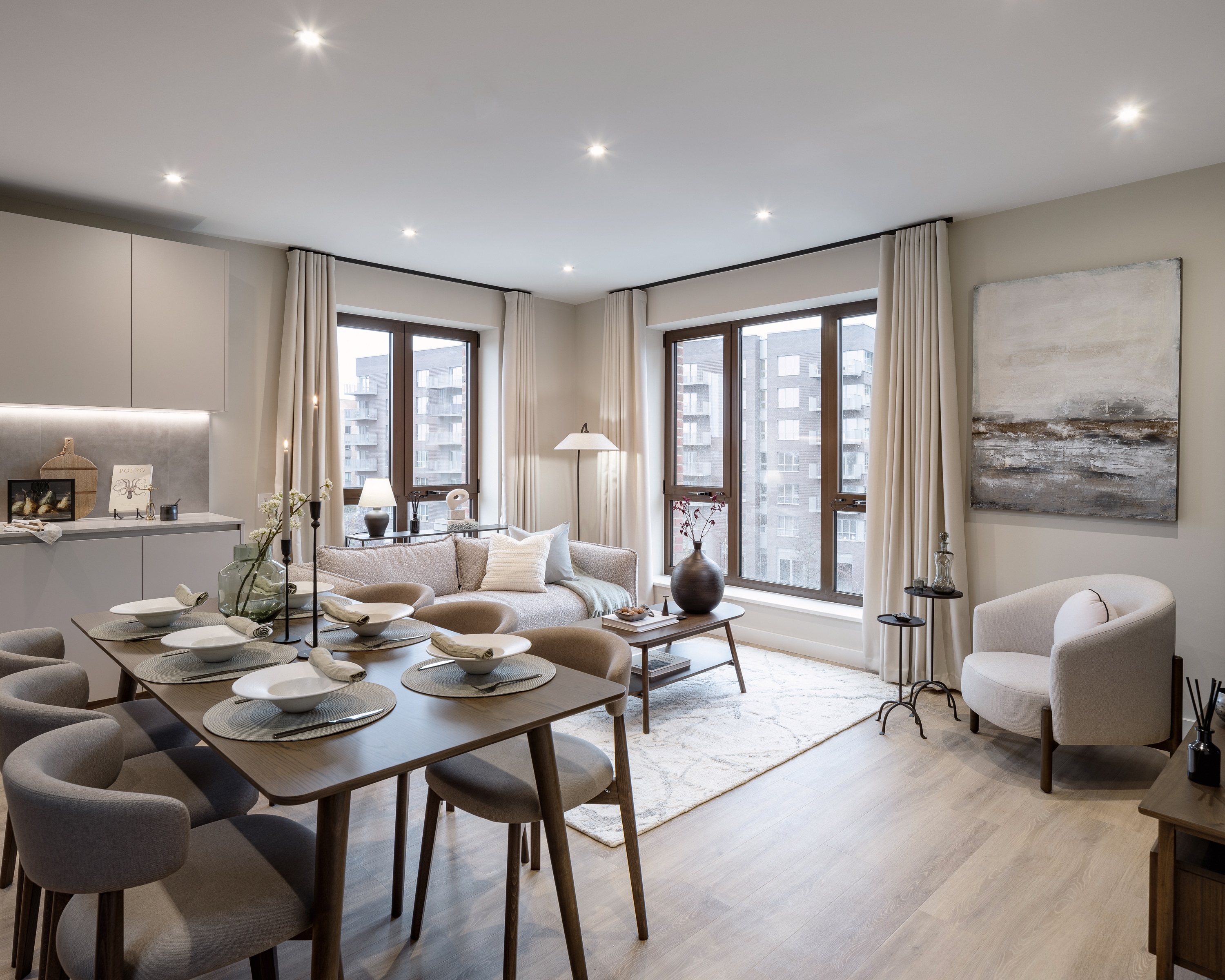 A dining and living area with views of residential buildings through the windows