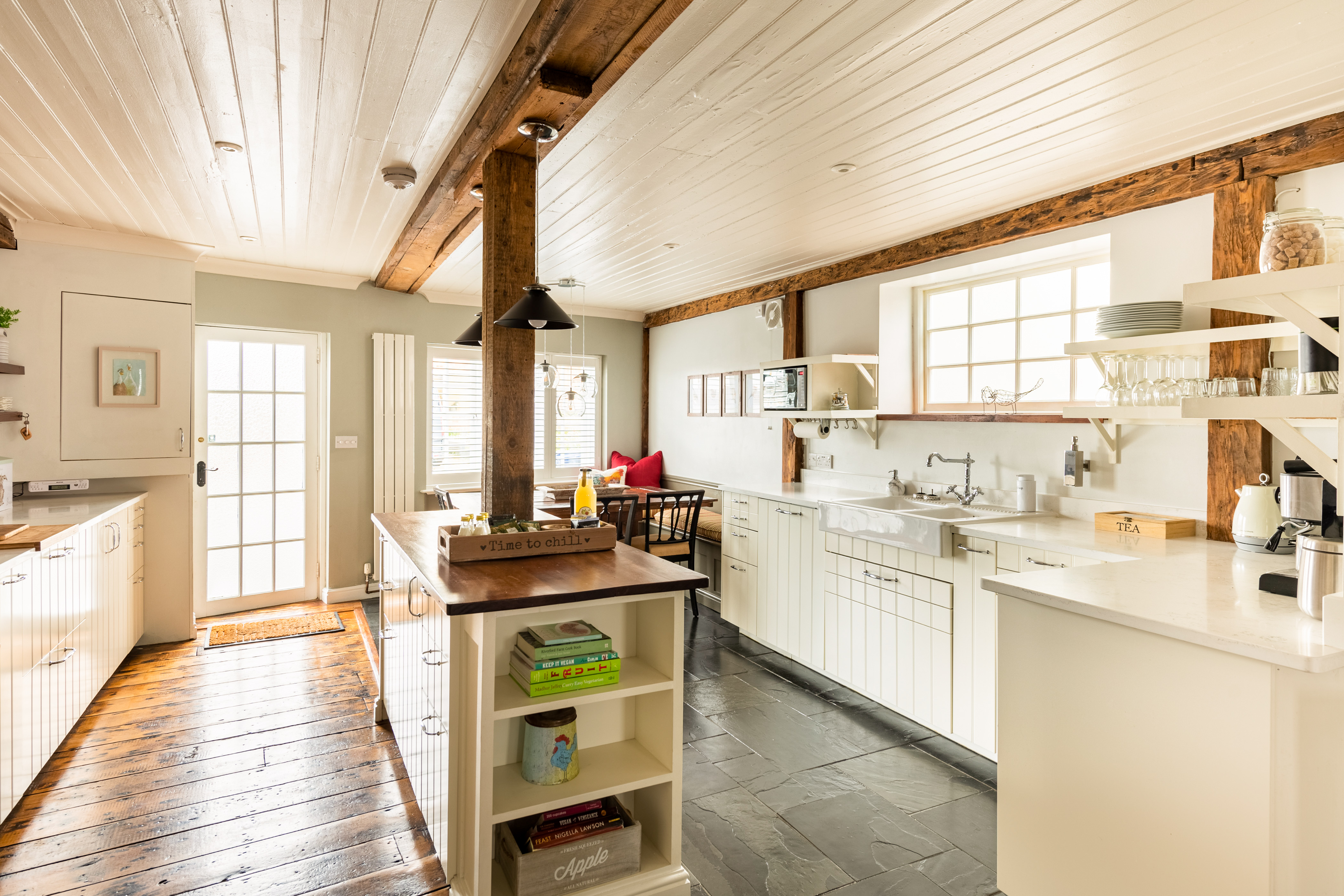Kitchen with wood fixtures and white tiled cabinets