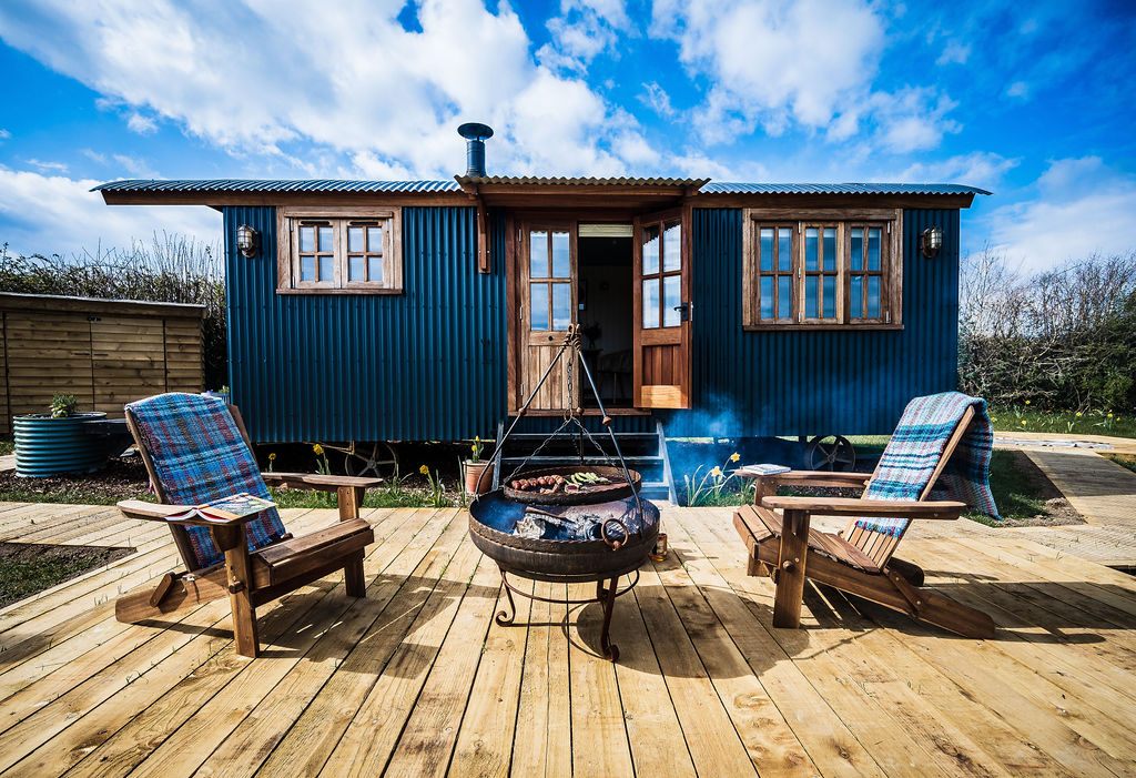 Blue tiny home with wooden floors