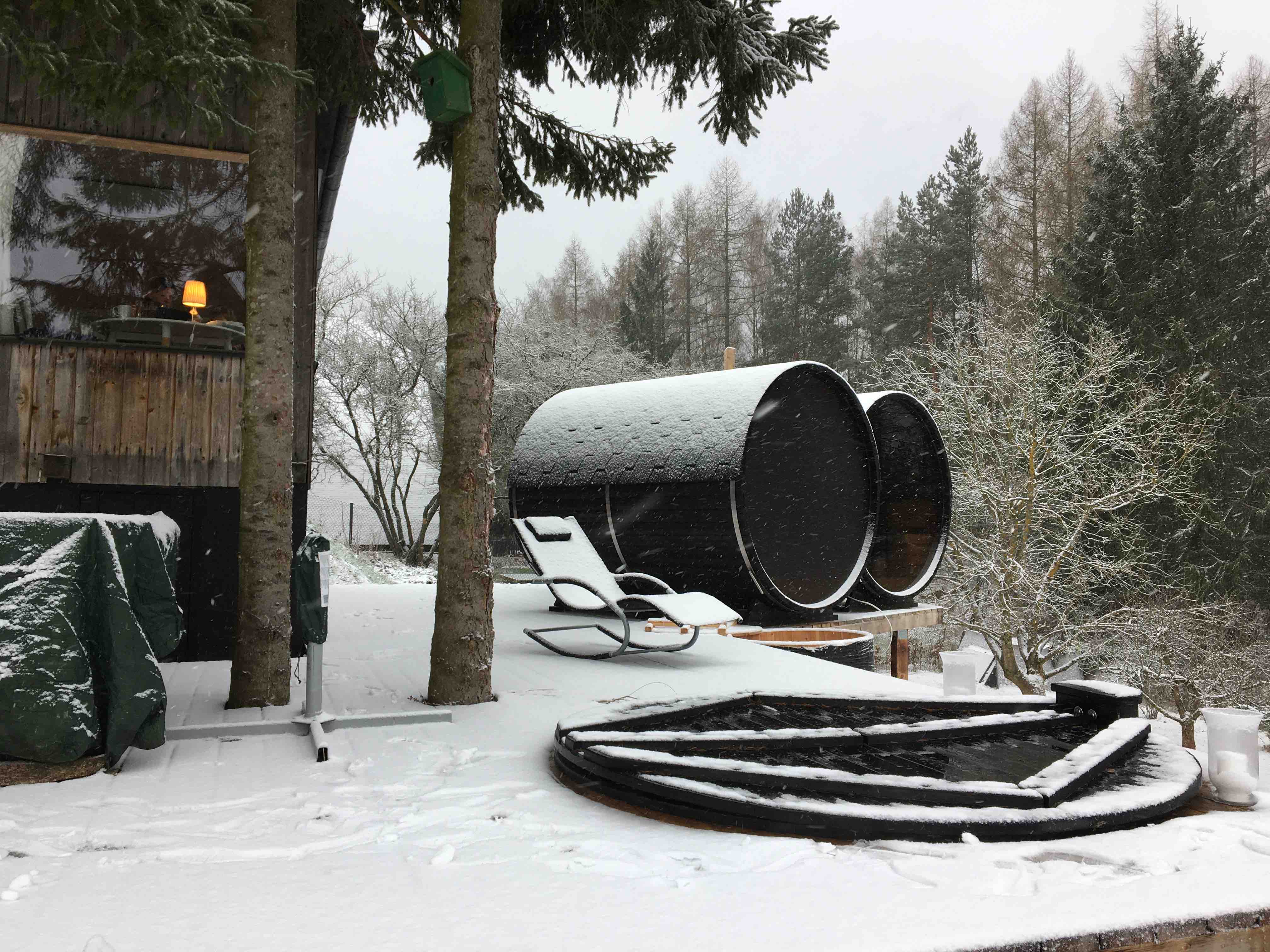 Wooden barrel saunas surrounded by snow