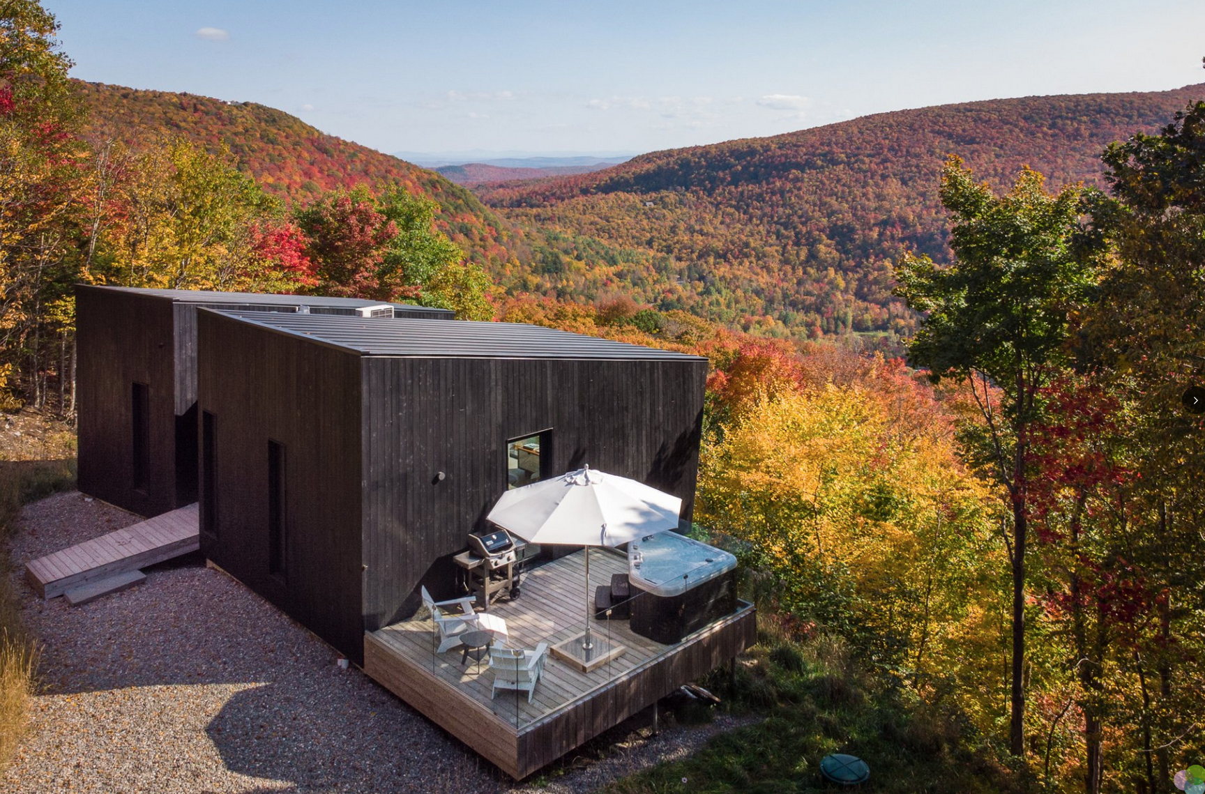 Tiny home that is surrounded by fall foliage