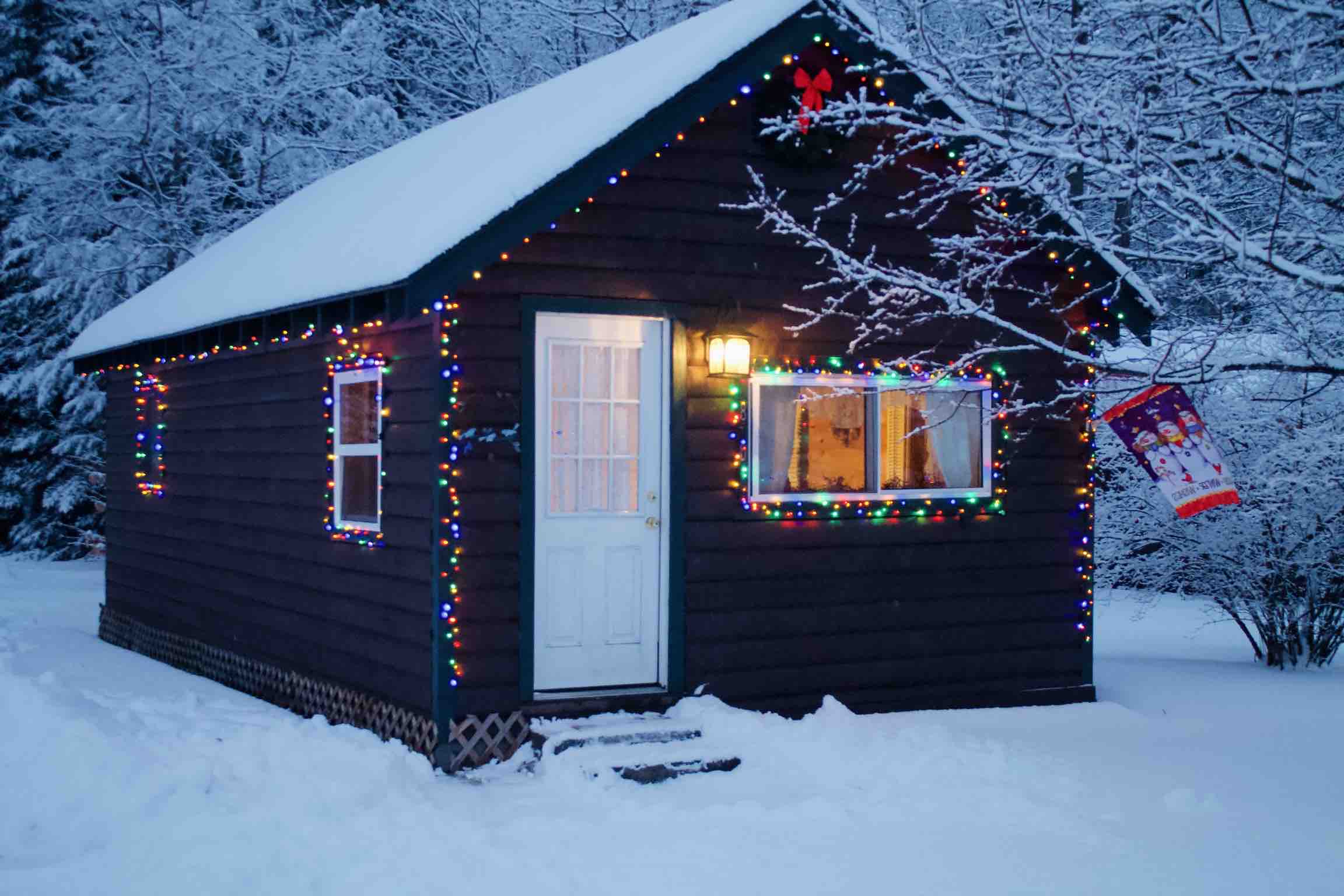 Small cabin decorated with Christmas lights