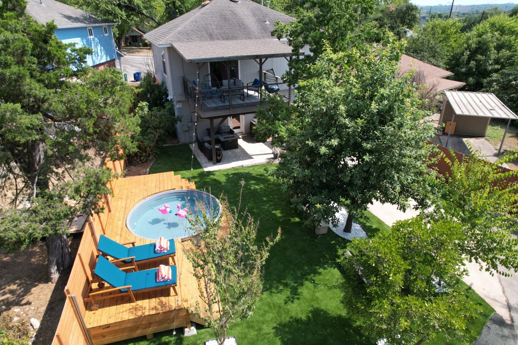 Exterior of house with small pool and wooden deck