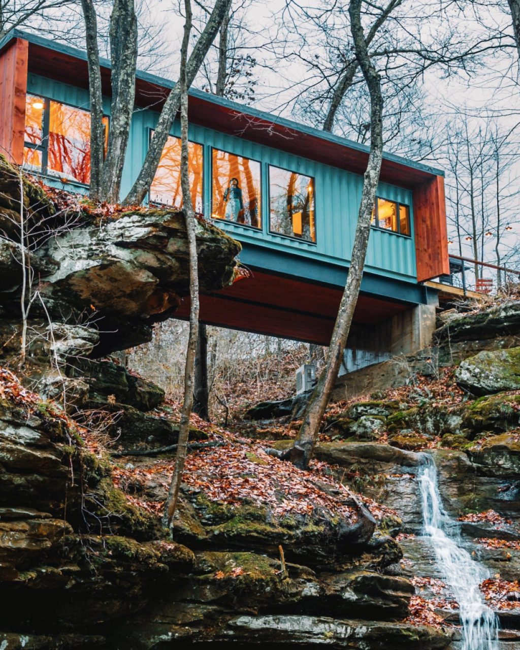 Container house over a waterfall