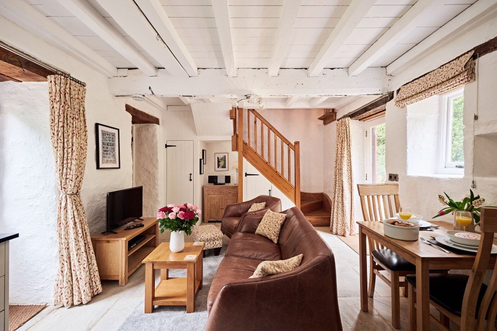 Interior of a cottage with a brown cottage and wooden stairwell