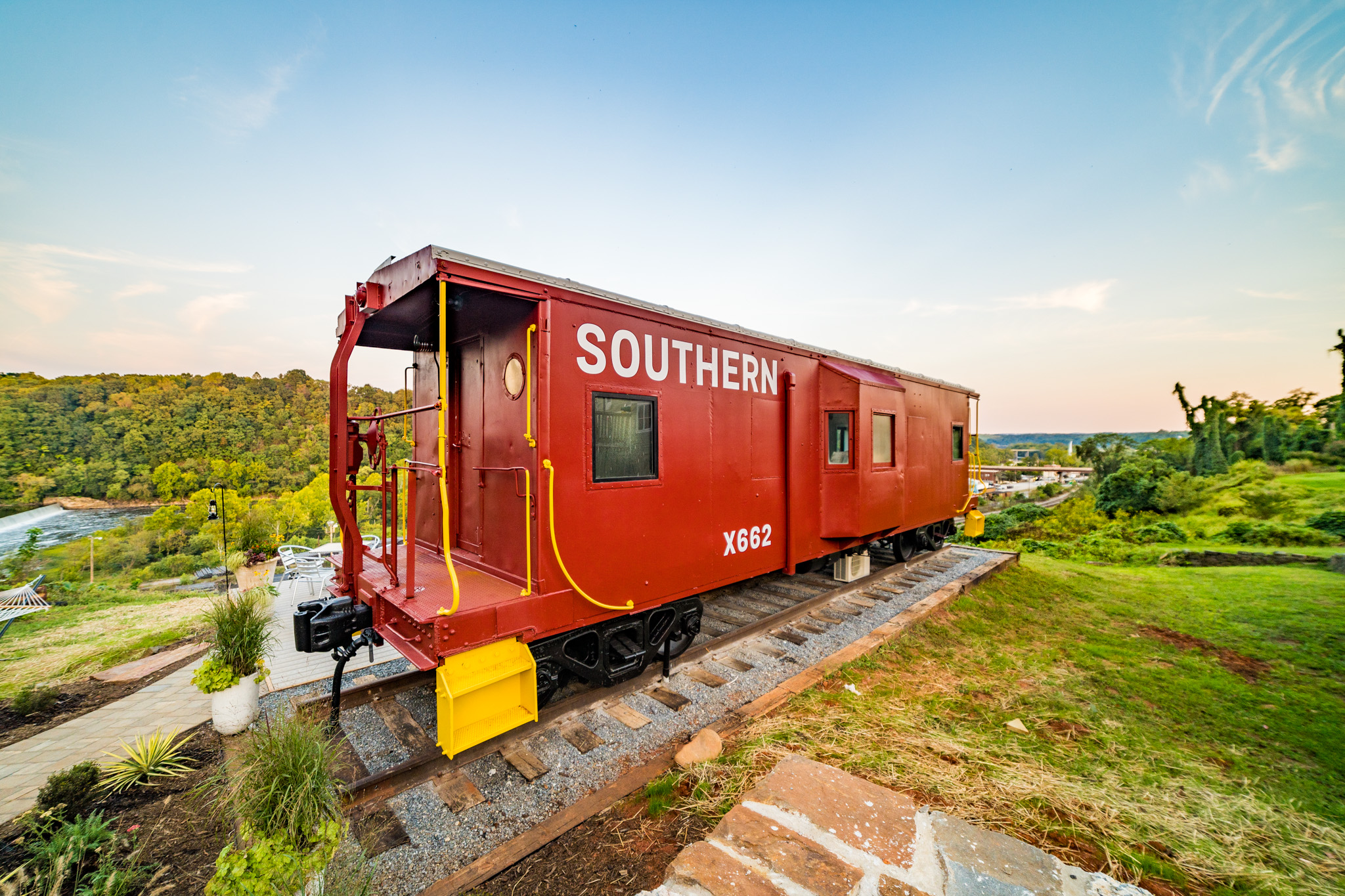 Red train caboose in green field