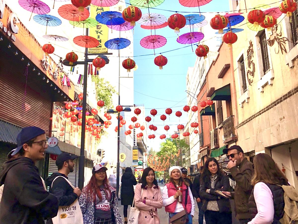 Cinematic tour of Mexico City’s Movie Landmarks A tour group under colorful umbrellas