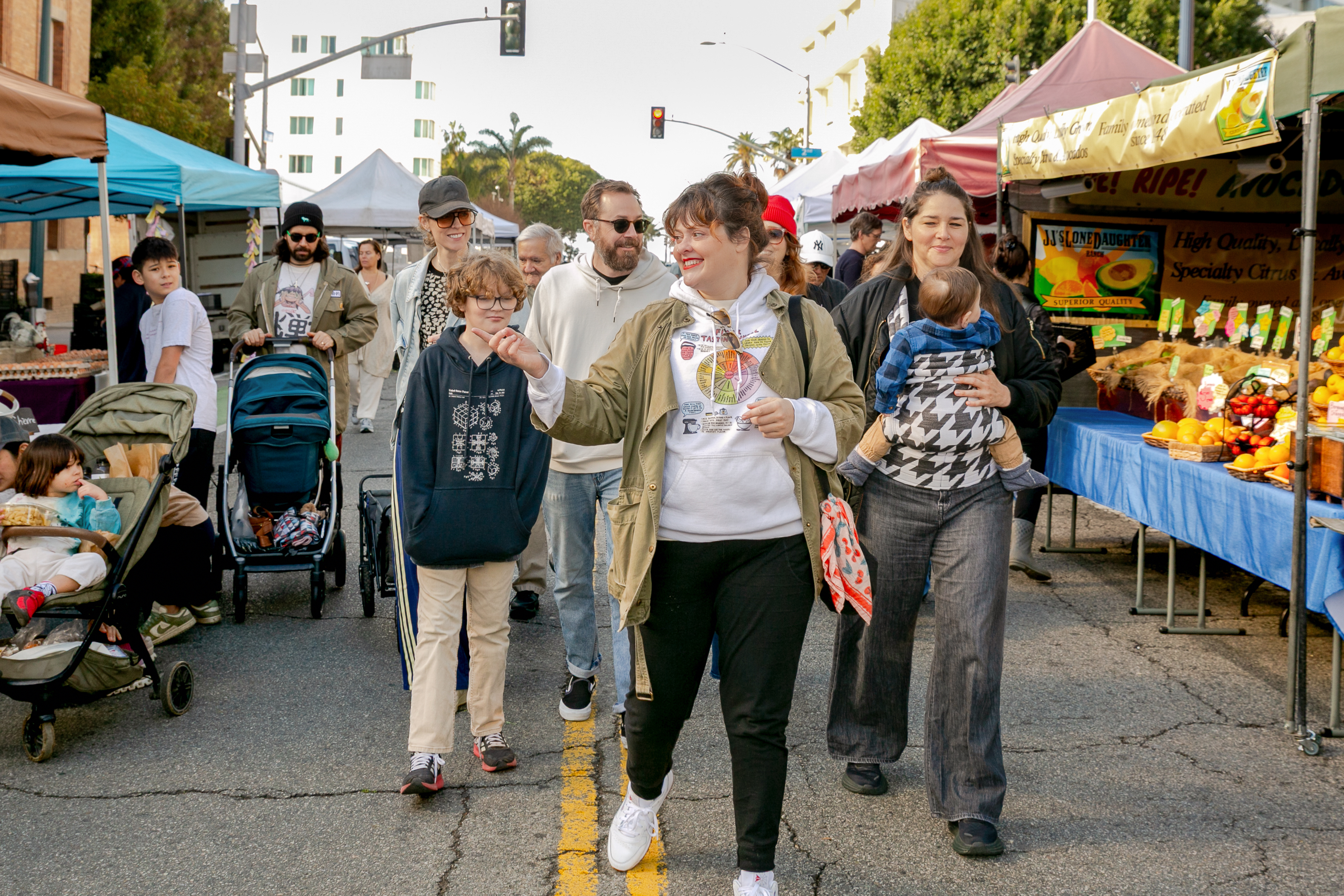 Woman guiding a group of people through a farmers market