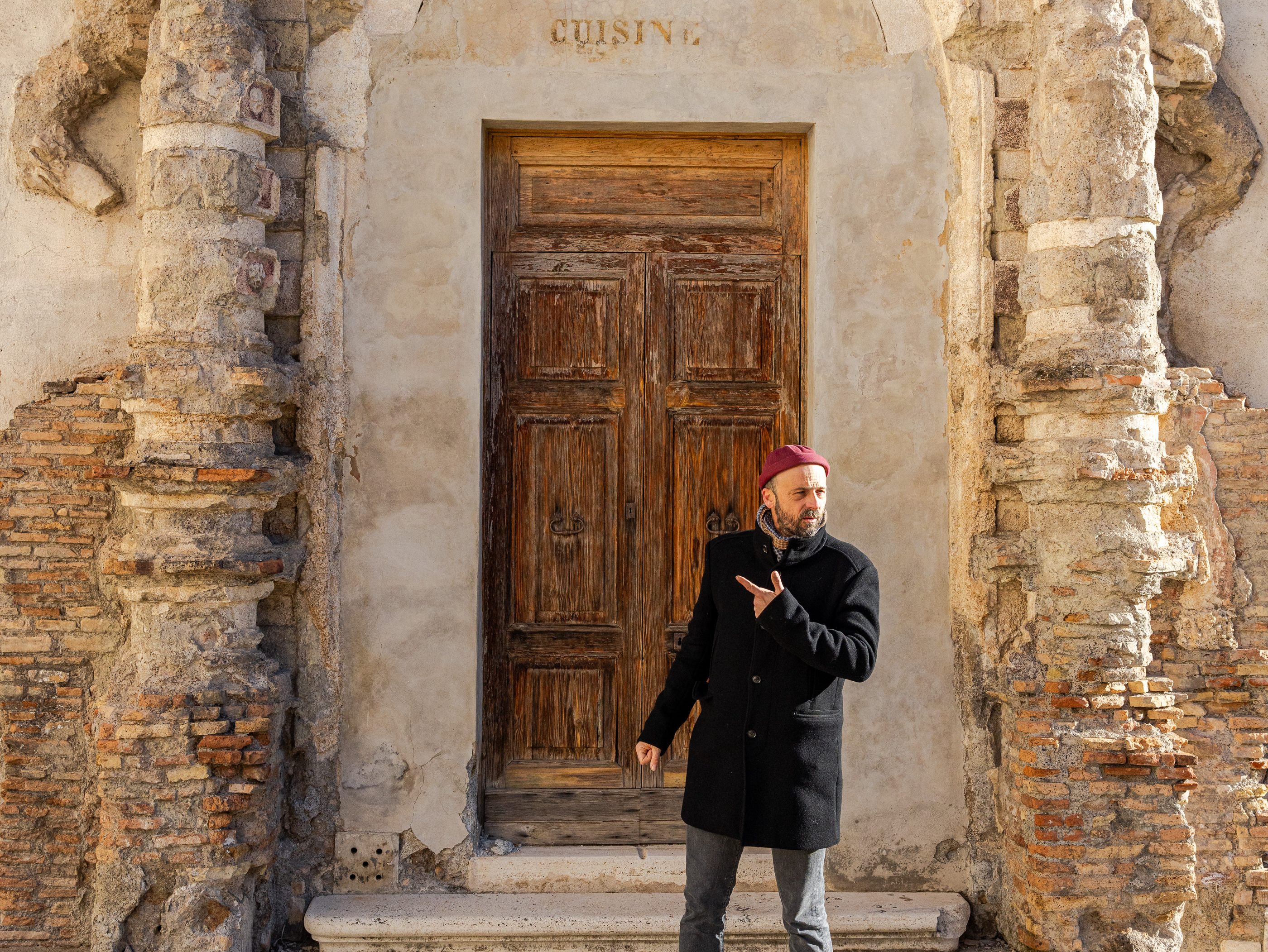 Man standing in front of baroque architecture door