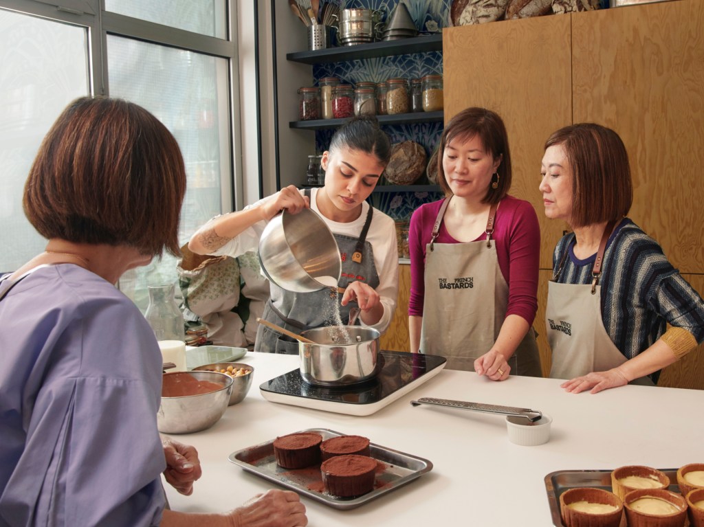Pastry chef pouring sugar into a bowl