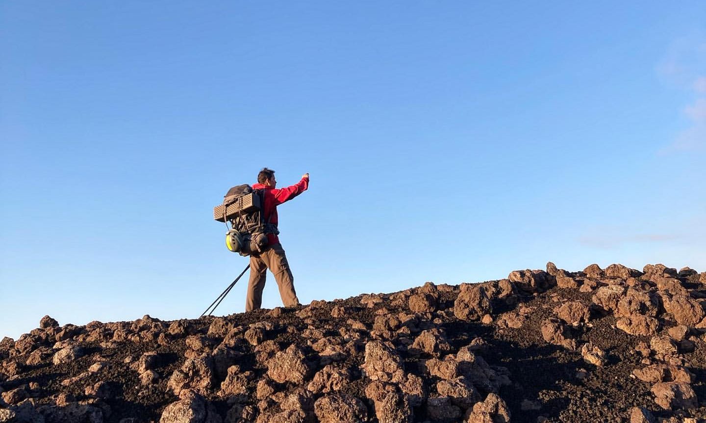 Man hiking on a volcanic slope